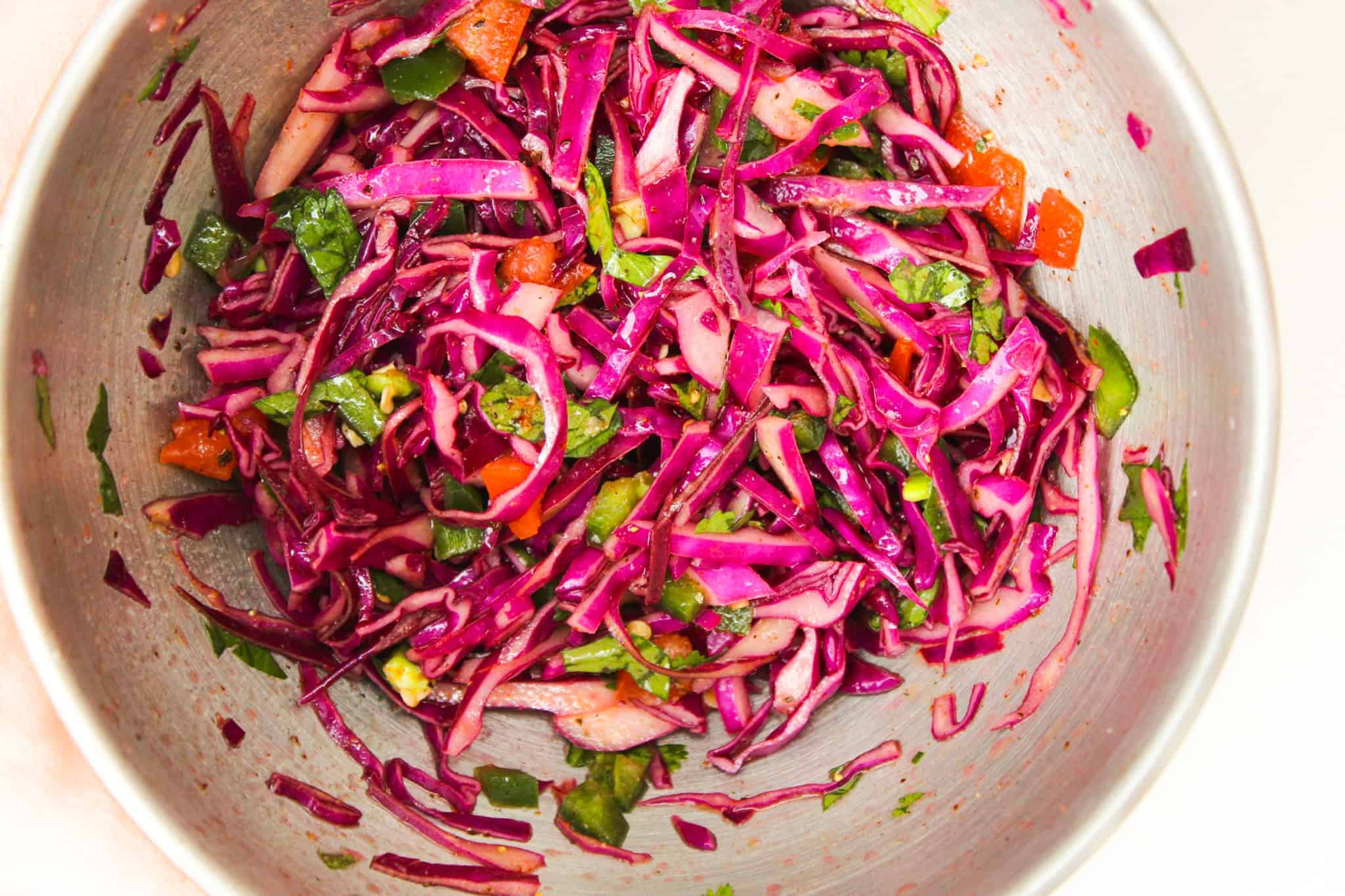 Overhead image of Asian slaw with red cabbage, cilantro, and jalapeno.