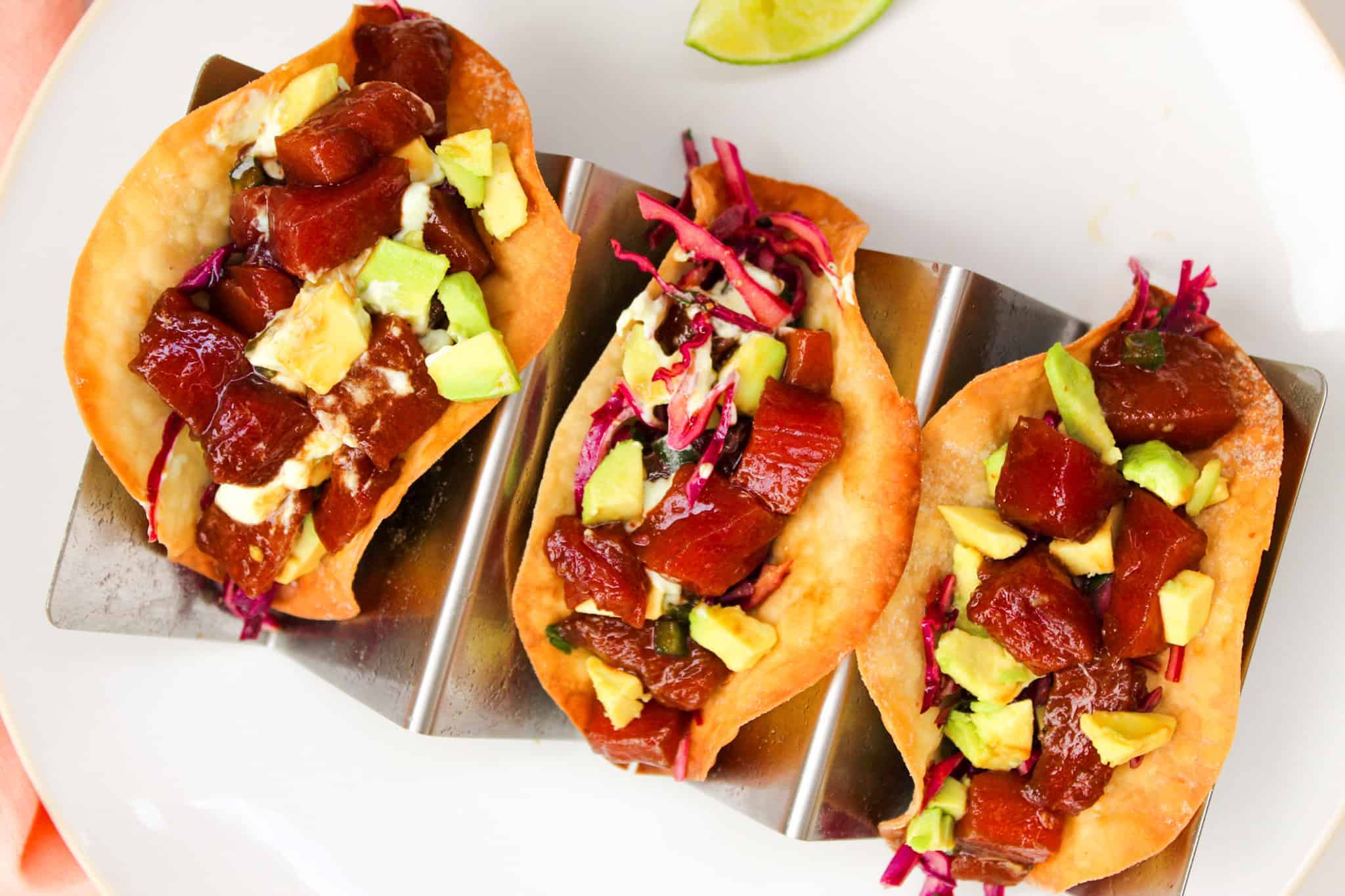 Poke tacos stuffed with fresh tuna, cabbage slaw, and wasabi sauce.