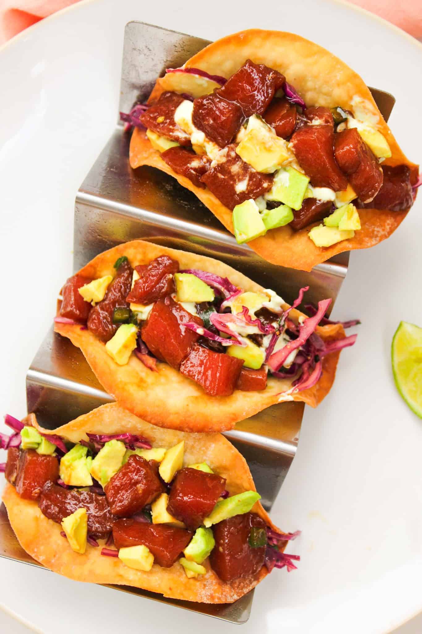 Tuna tacos with Asian slaw placed in taco holder.