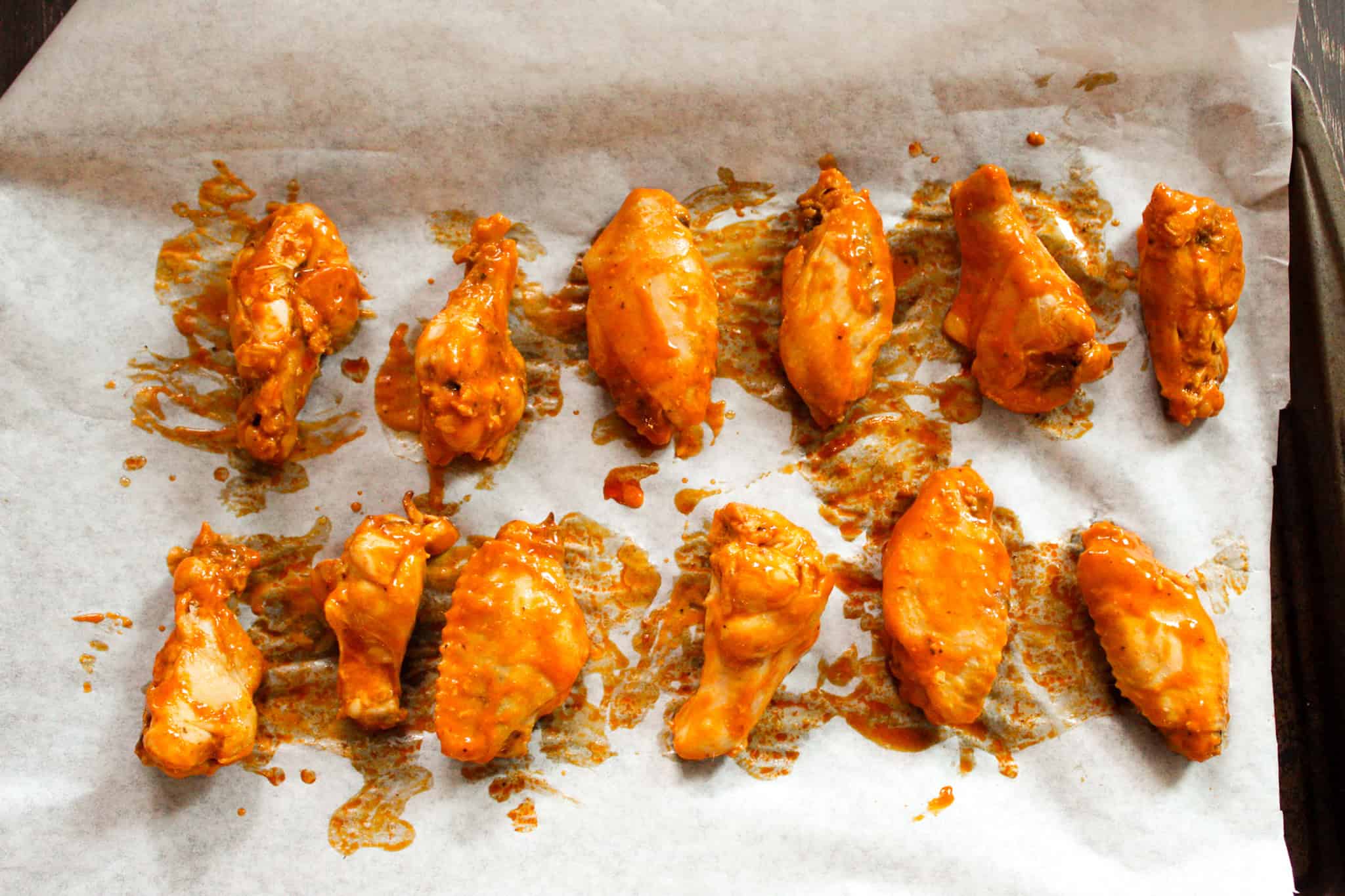 Buffalo wings on a baking sheet. 