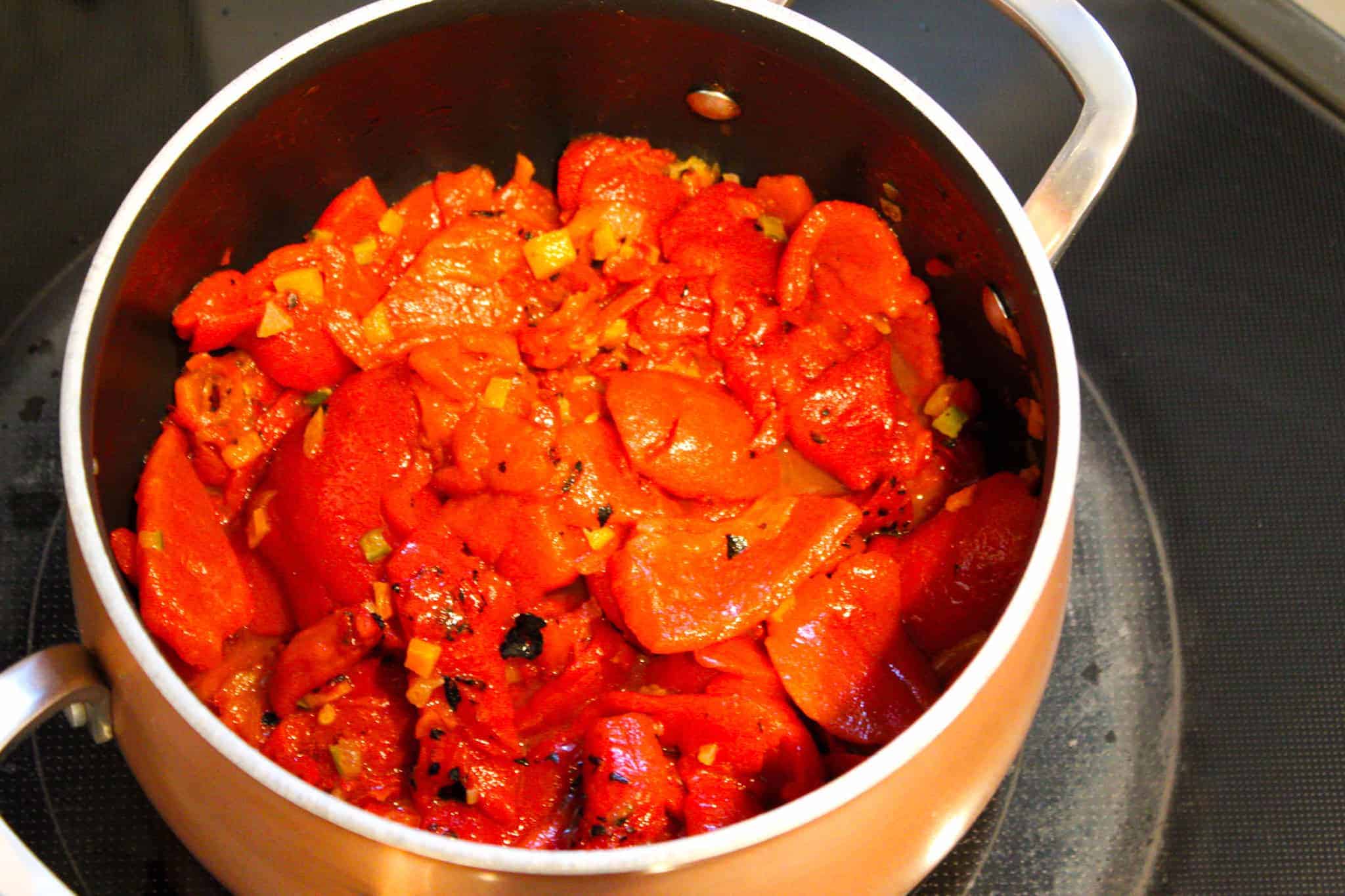 Sauteing peppers in a copper pot.
