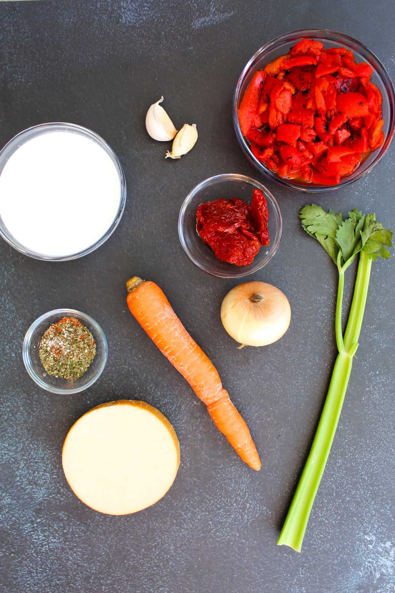 Roasted red pepper soup ingredients on a grey counter.