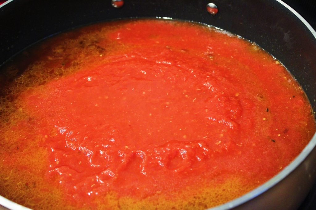 add crushed tomatoes