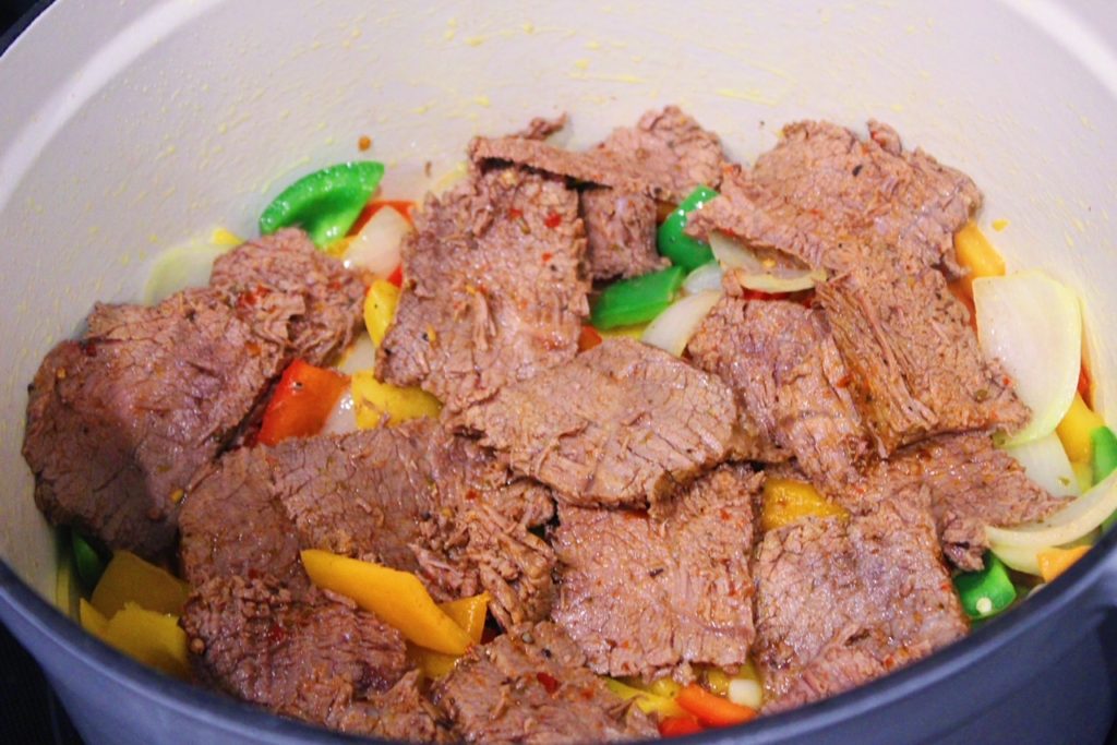 simmering beef and veggies in pot 
