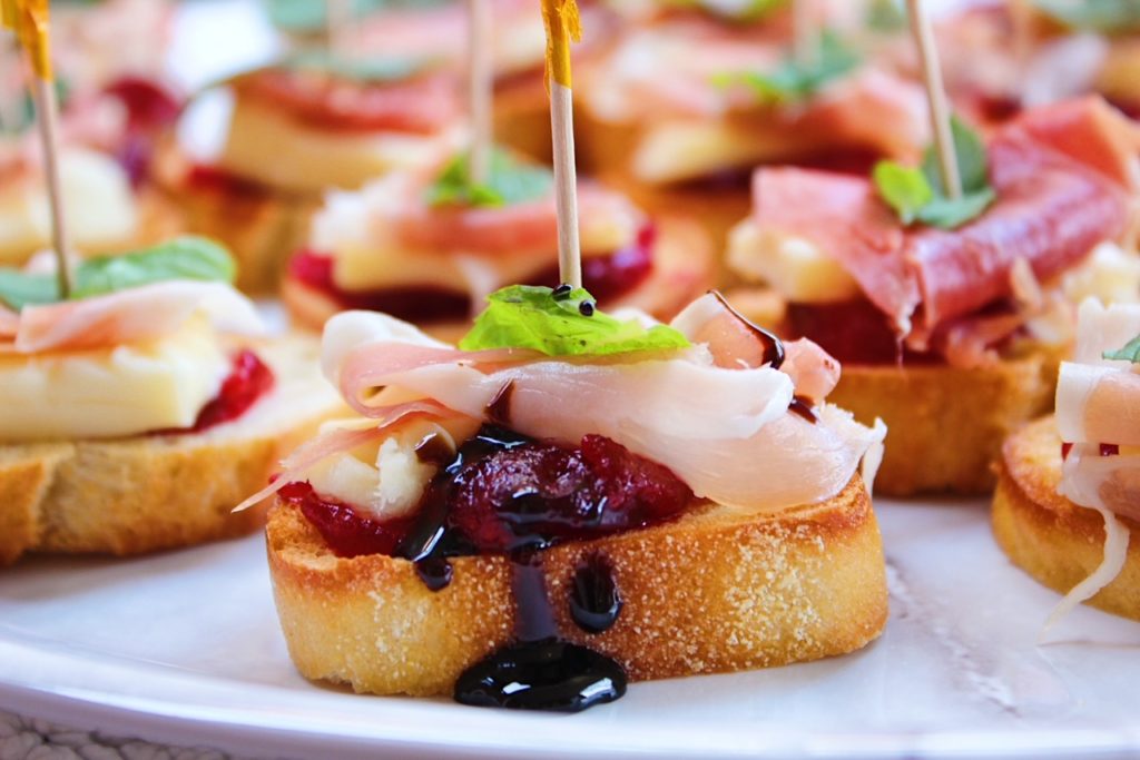 Brie & Prosciutto Crostini with Cranberry and Mint close up