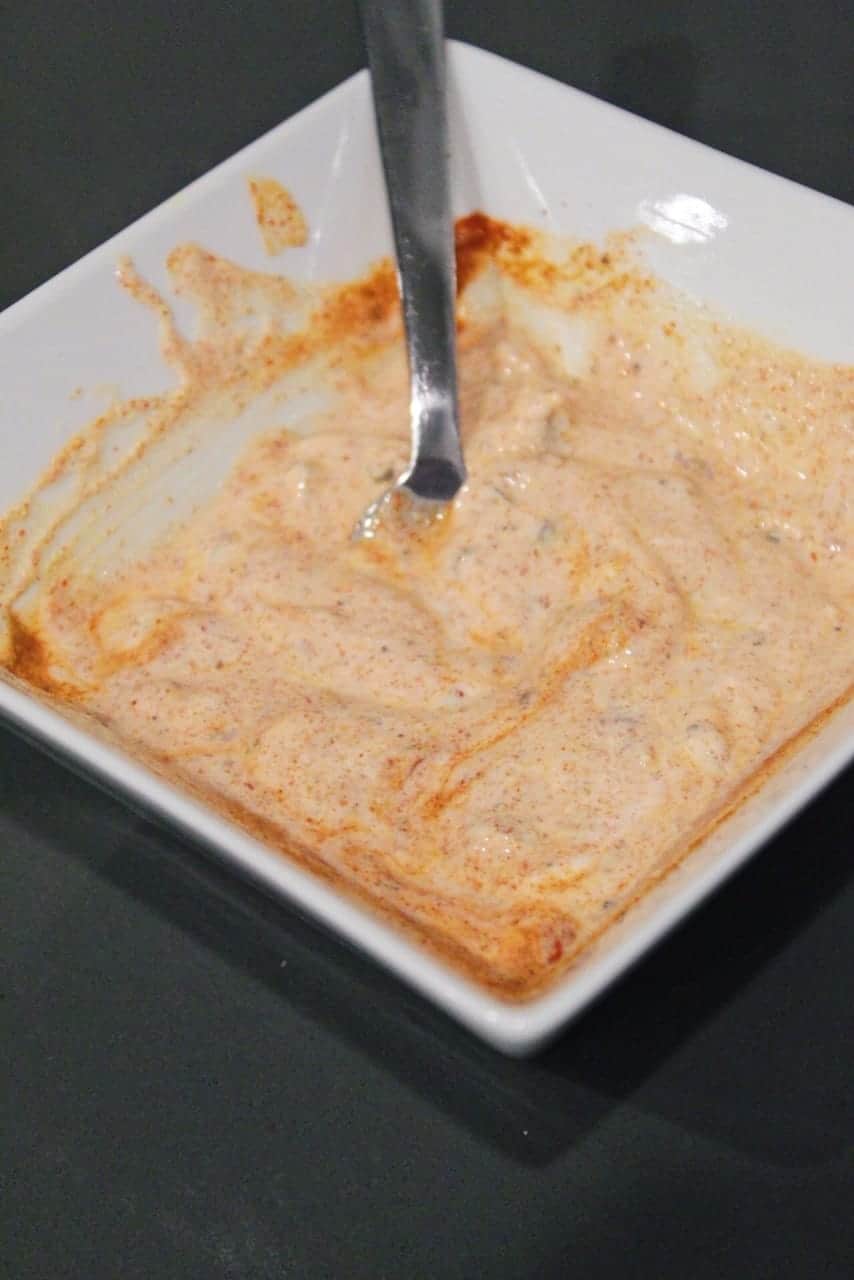Homemade pale orange Taco Bell Quesadilla sauce with Greek Yogurt in a white bowl.