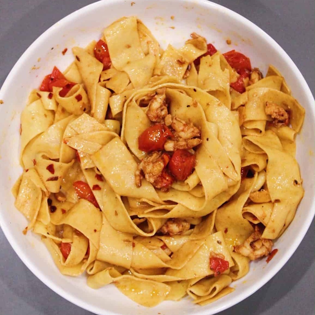 Lobster Pappardelle in white bowl.
