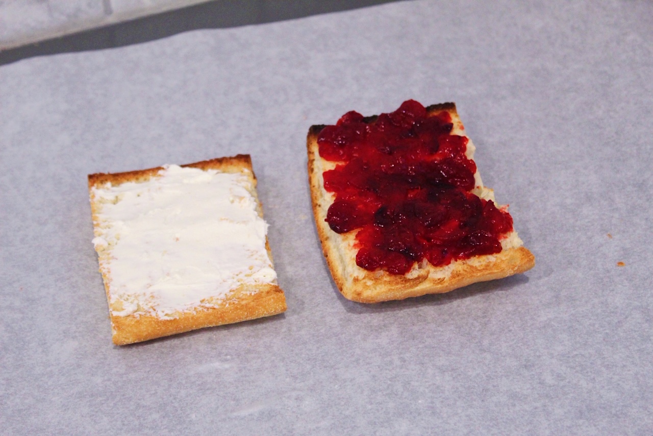 ciabatta bread slices spread with cream cheese and cranberry