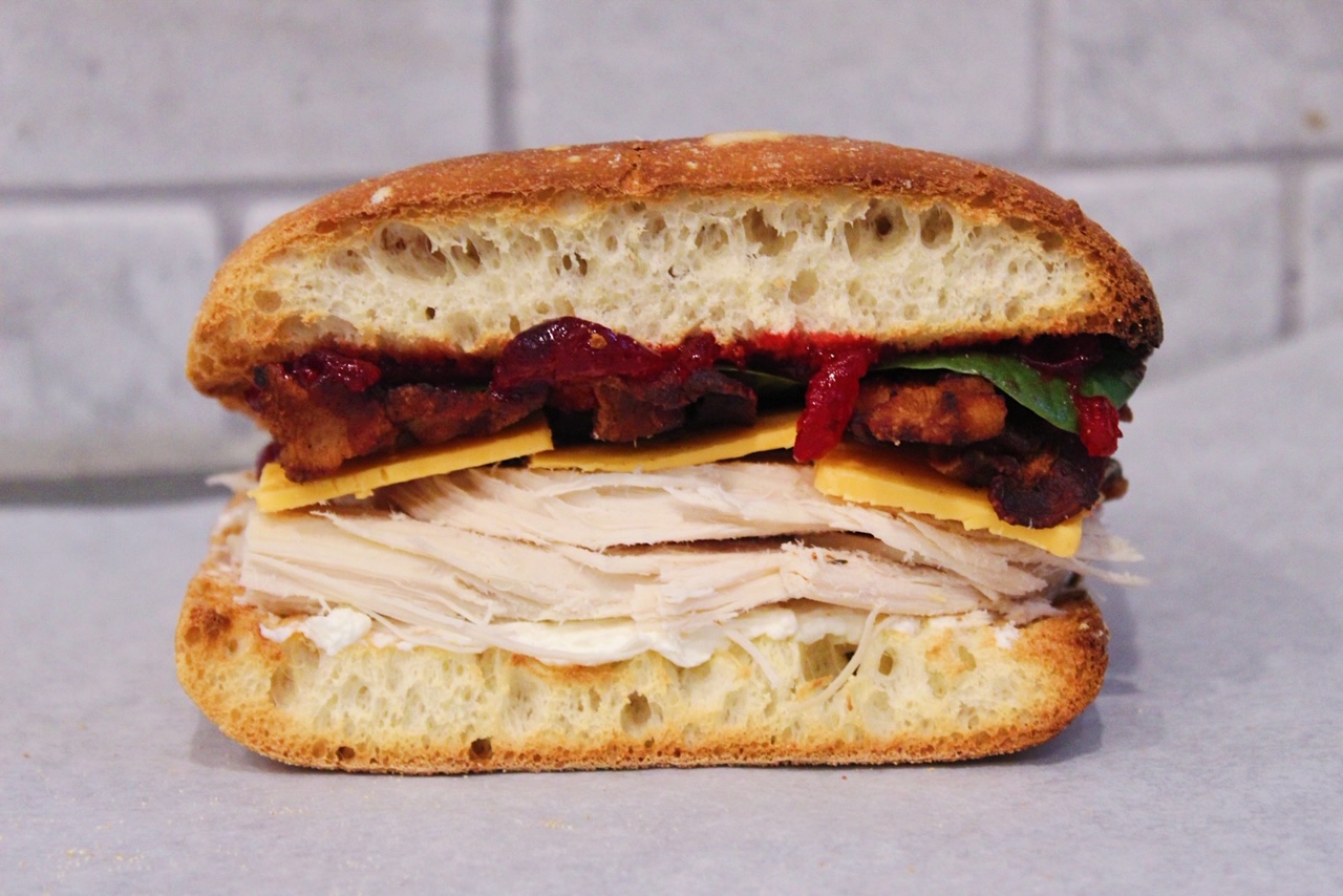close up of thanksgiving sandwich on parchment paper