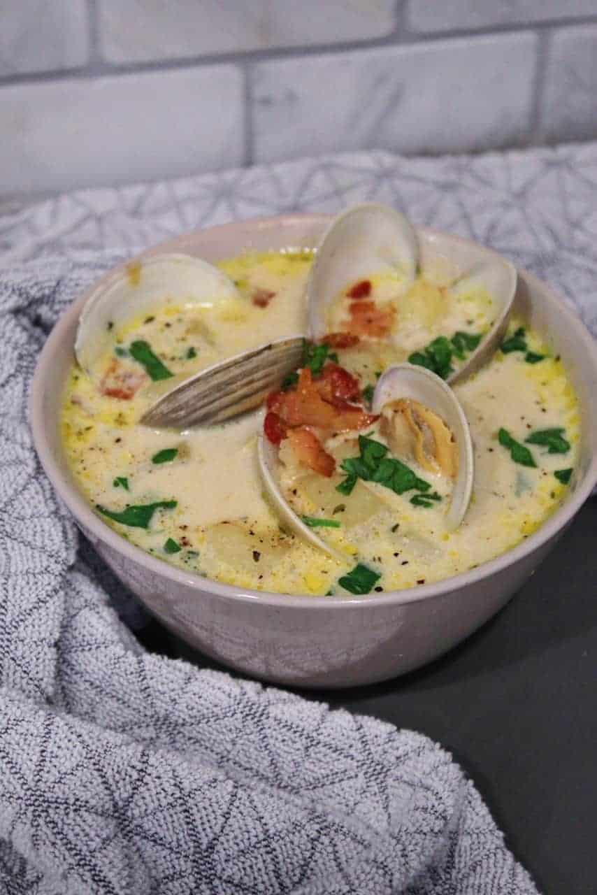 Tan bowl full of homemade New England clam chowder.