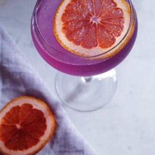 Close up shot from above of pink/purple Grapefruit Empress Gin cocktail.