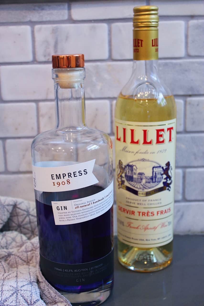 Bottle of Empress 1908 Gin next to bottle of Lillet Blanc.