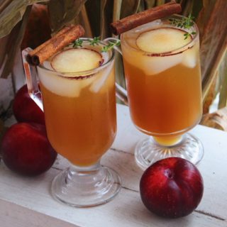 Apple Cider Bourbon Cocktail (with Plums & Thyme) with festive fall background