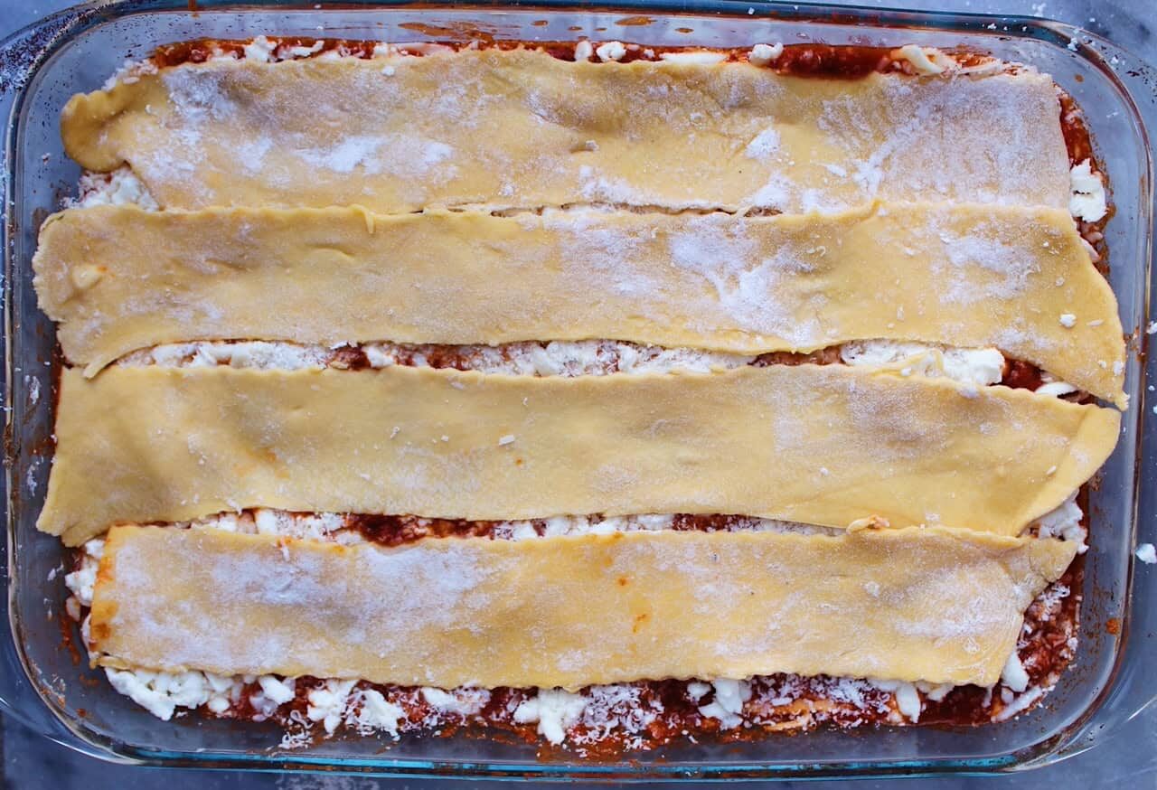 Fresh noodle layer during assemble of lasagna.