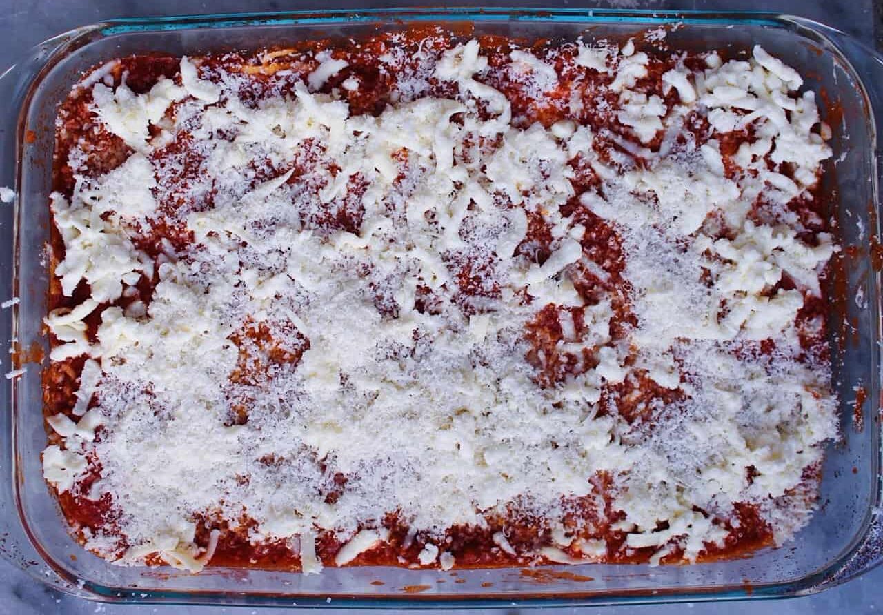 Parmesan layer over mozzarella and red meat sauce.