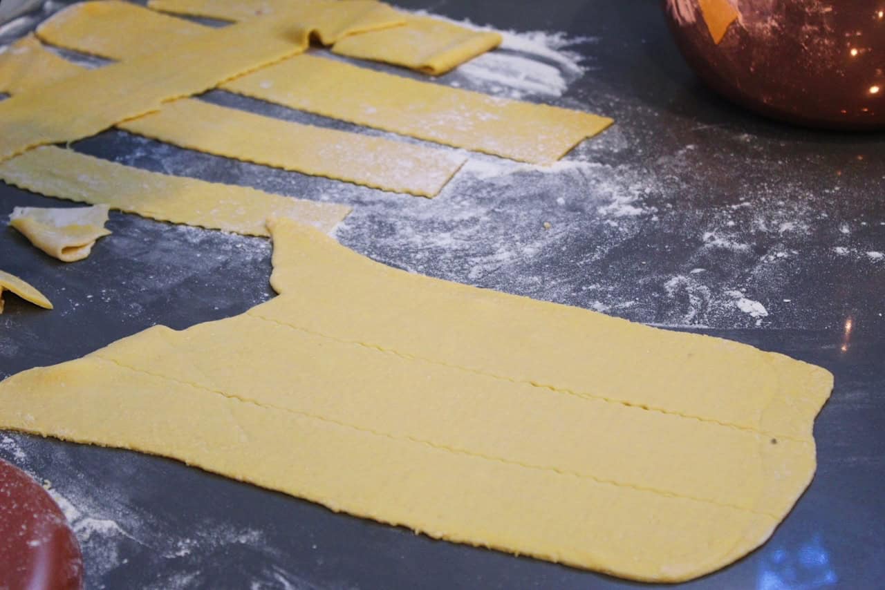 Fresh lasagna sheets on a grey countertop.