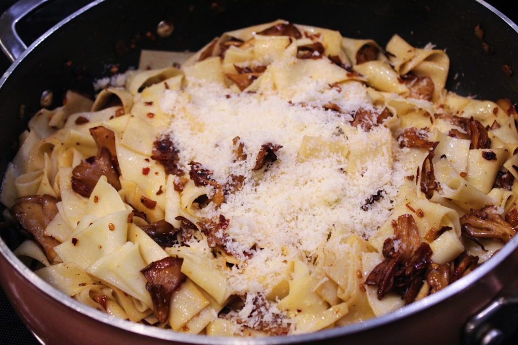 adding fresh Parmesan