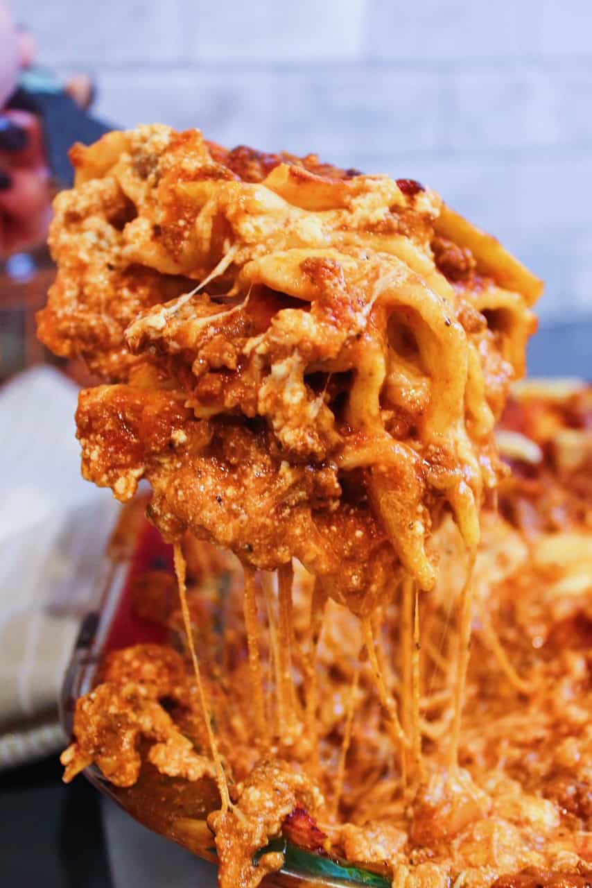 Cheese pull when scooping a slice of lasagna out of casserole dish.