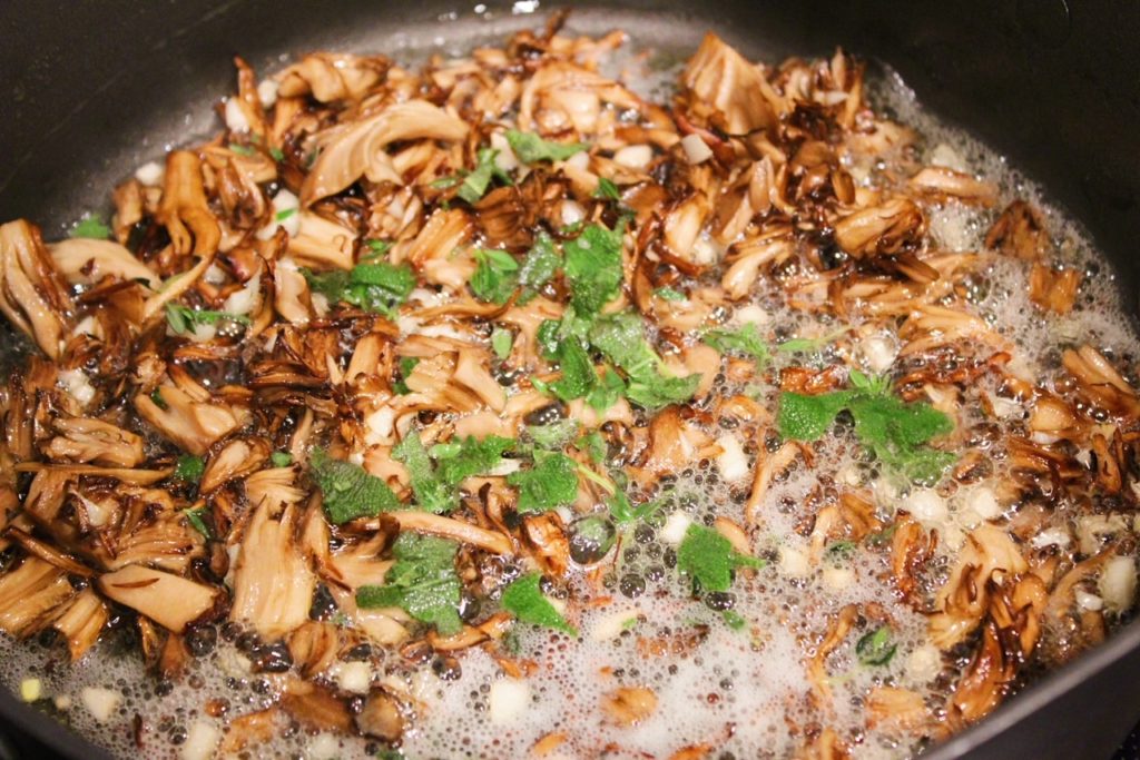 adding herbs to sauce