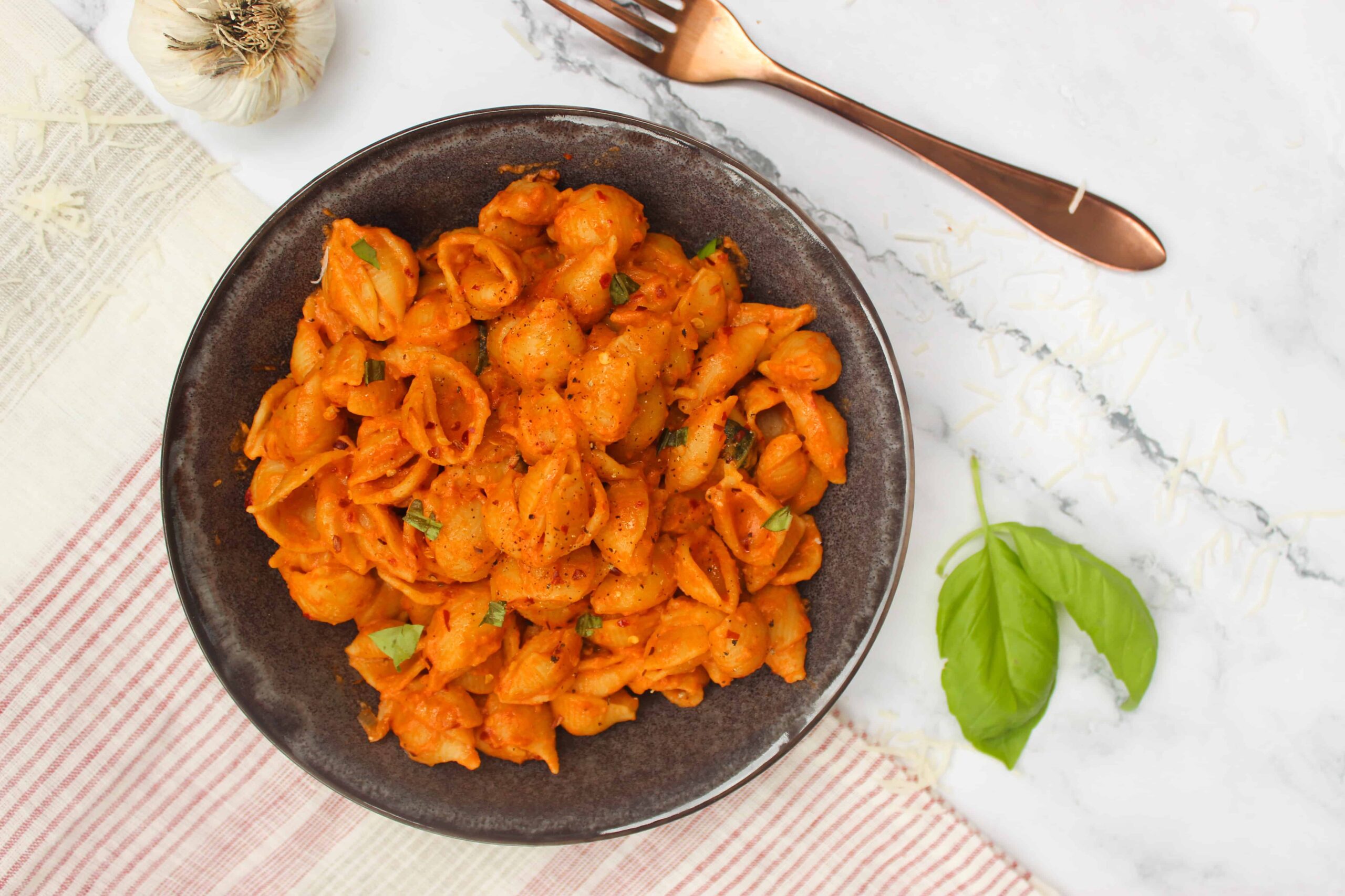 Gigi Hadid Pasta with Spicy Vodka Sauce in a charcoal bowl on a dish towel.