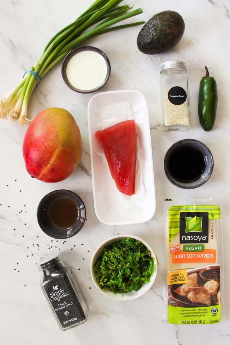 Overhead image of ingredients needed for Tuna Nachos on a marble counter. 